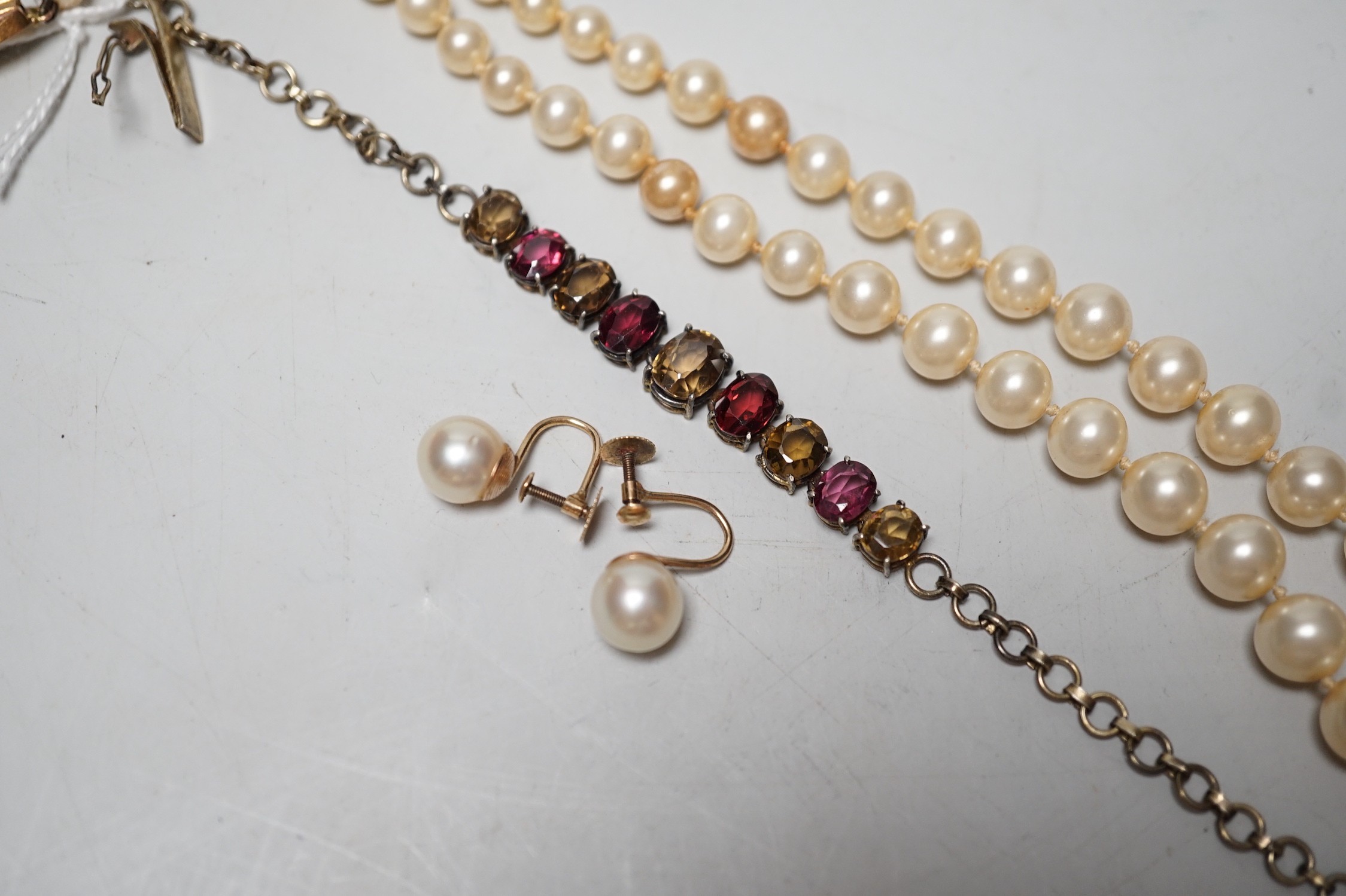 A gilt metal and coloured paste set bracelet, a pair of 9ct and cultured pearl set ear clips and a simulated pearl necklace, with 9ct clasp.